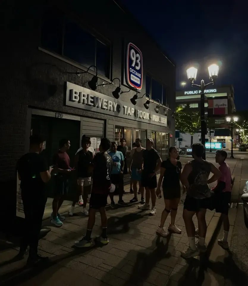 The group outside 93 Octane Brewery at night