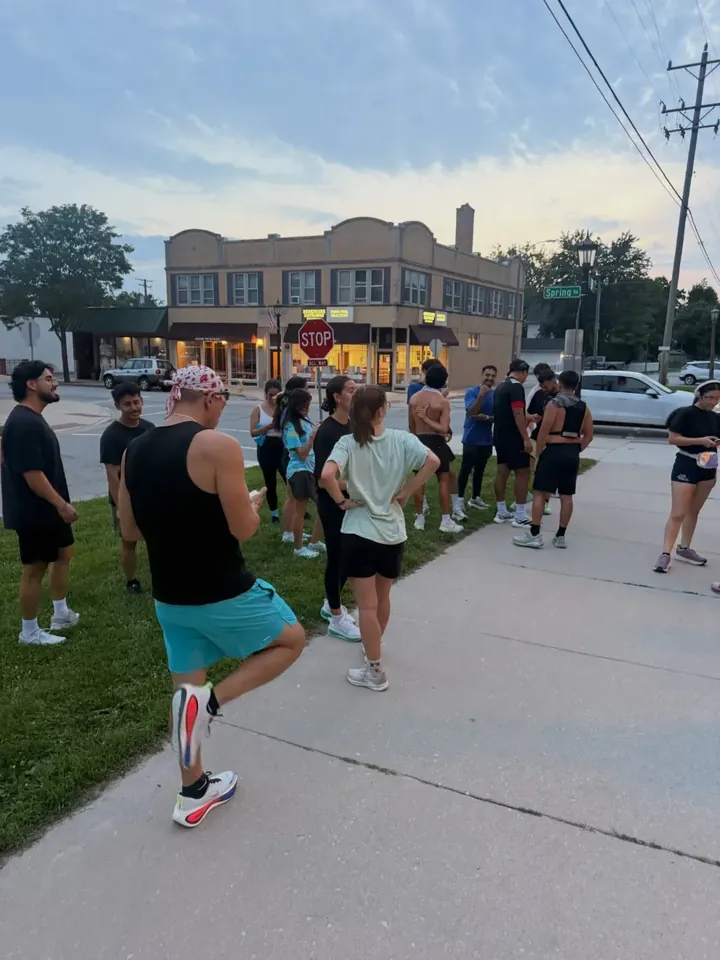 Runners stretching on a corner downtown before heading out