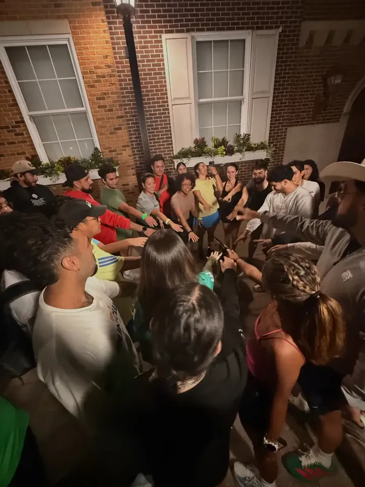 The crew huddled together for a hands-in at night