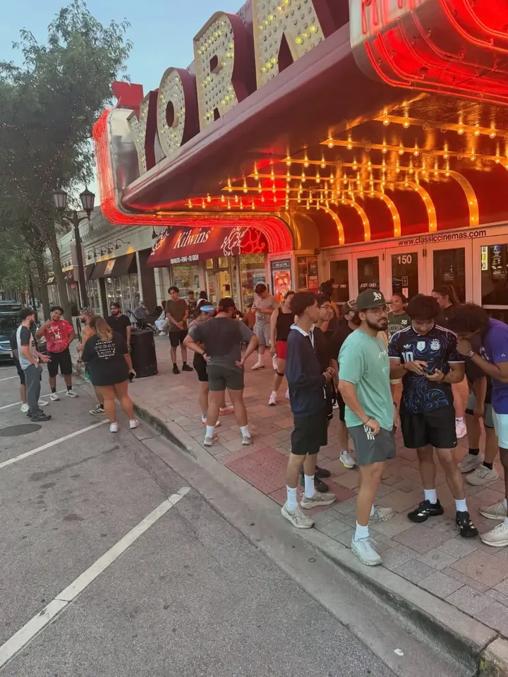 The group outside the lit-up York Theatre marquee