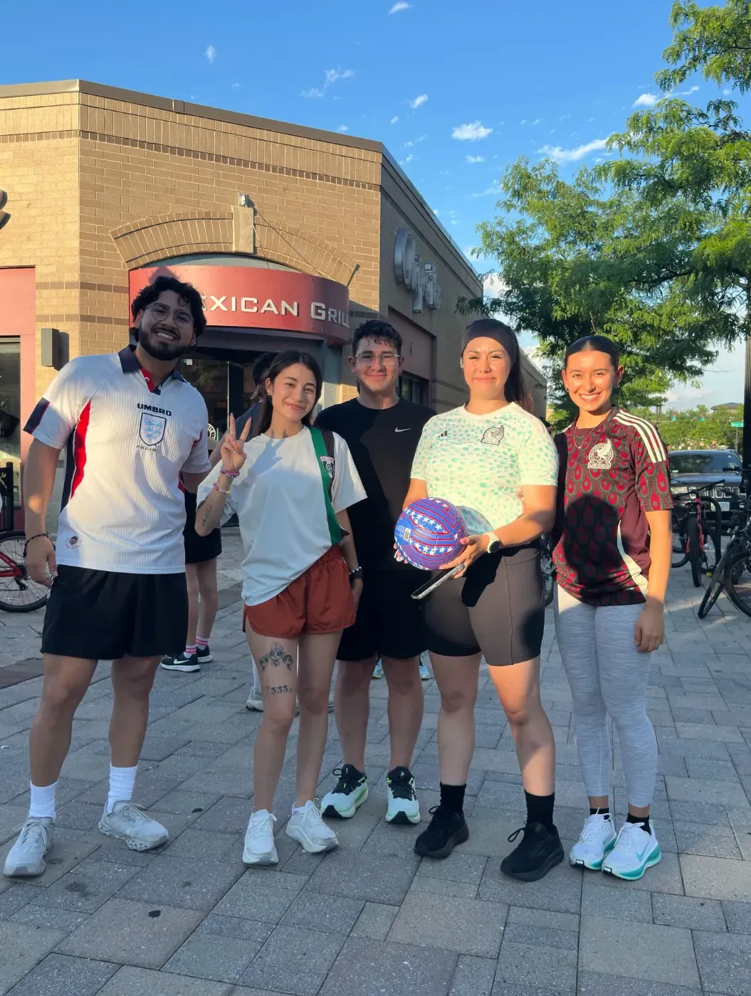 Runners with a soccer ball outside Chipotle on York Street before the run